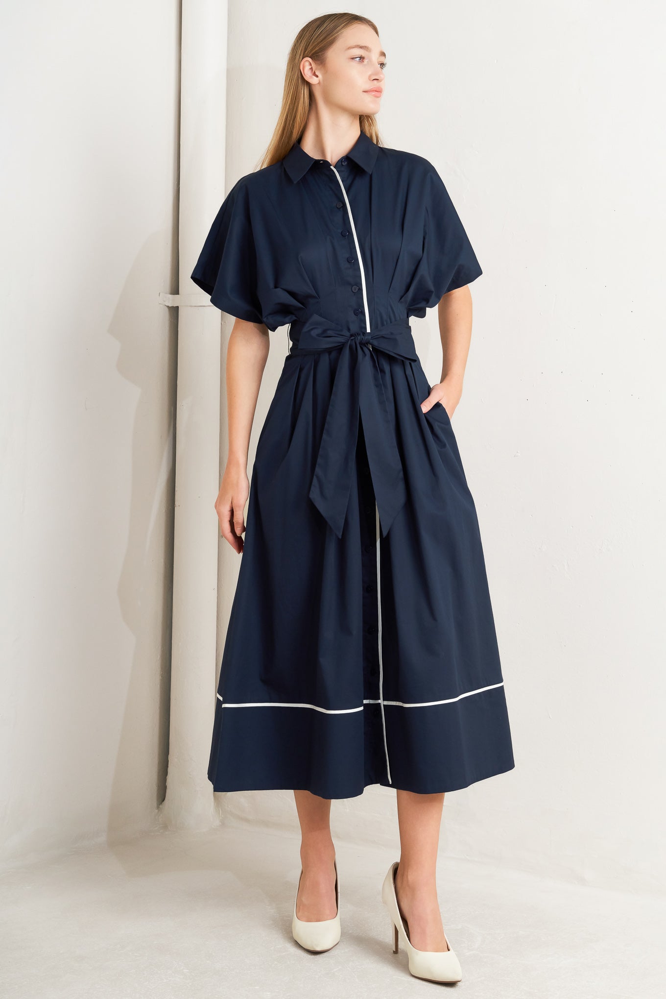 A solid woven midi dress featuring collar, short dolman sleeve, front button down, corset waist, self sash tie and piping detail


Details:

Self : 100% Cotton
Contrast : 100% Cotton

Size &amp; Fit

- Model is 5`8" And Wearing Size Small
- Measurements Taken From Size Small
- Approx. Length: 51" Flying Tomato