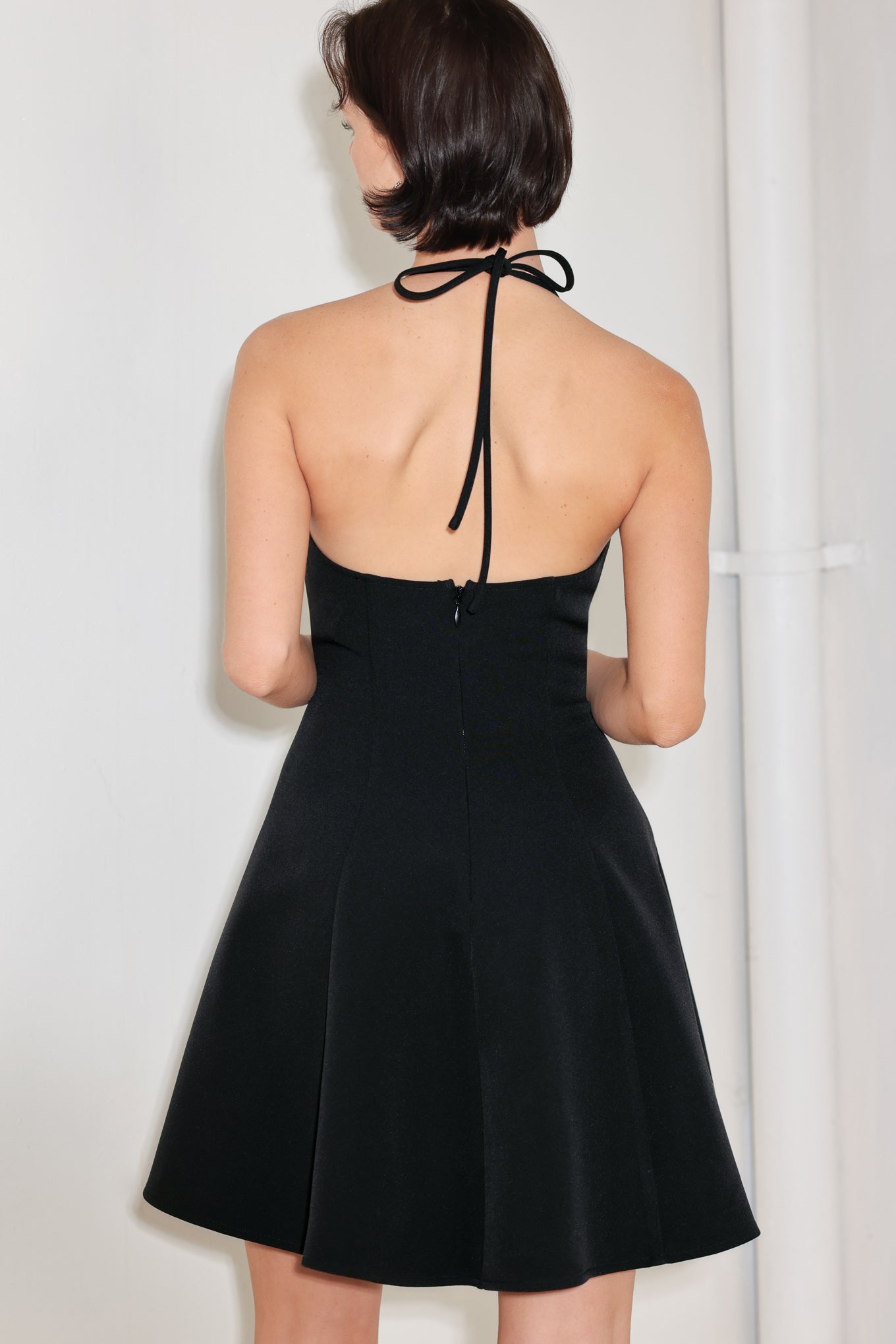 A solid woven mini dress featuring halter neckline with back neck tie, circle skirt, bare back and zipper closure

Details:

Self : 96% Polyester 4% Spandex

Size & Fit

-Model is 5`8" And Wearing Size Small
-Measurements Taken From Size Small
-Approx. Length: 36"