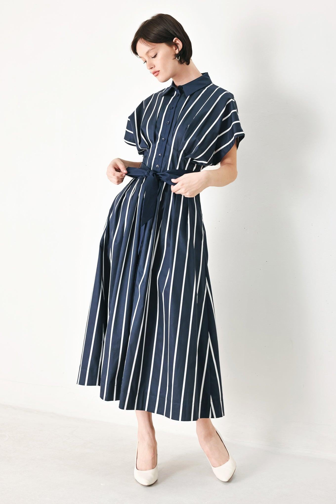 A striped woven midi dress featuring collar, button down, corset waist, solid self sash tie and full skirt