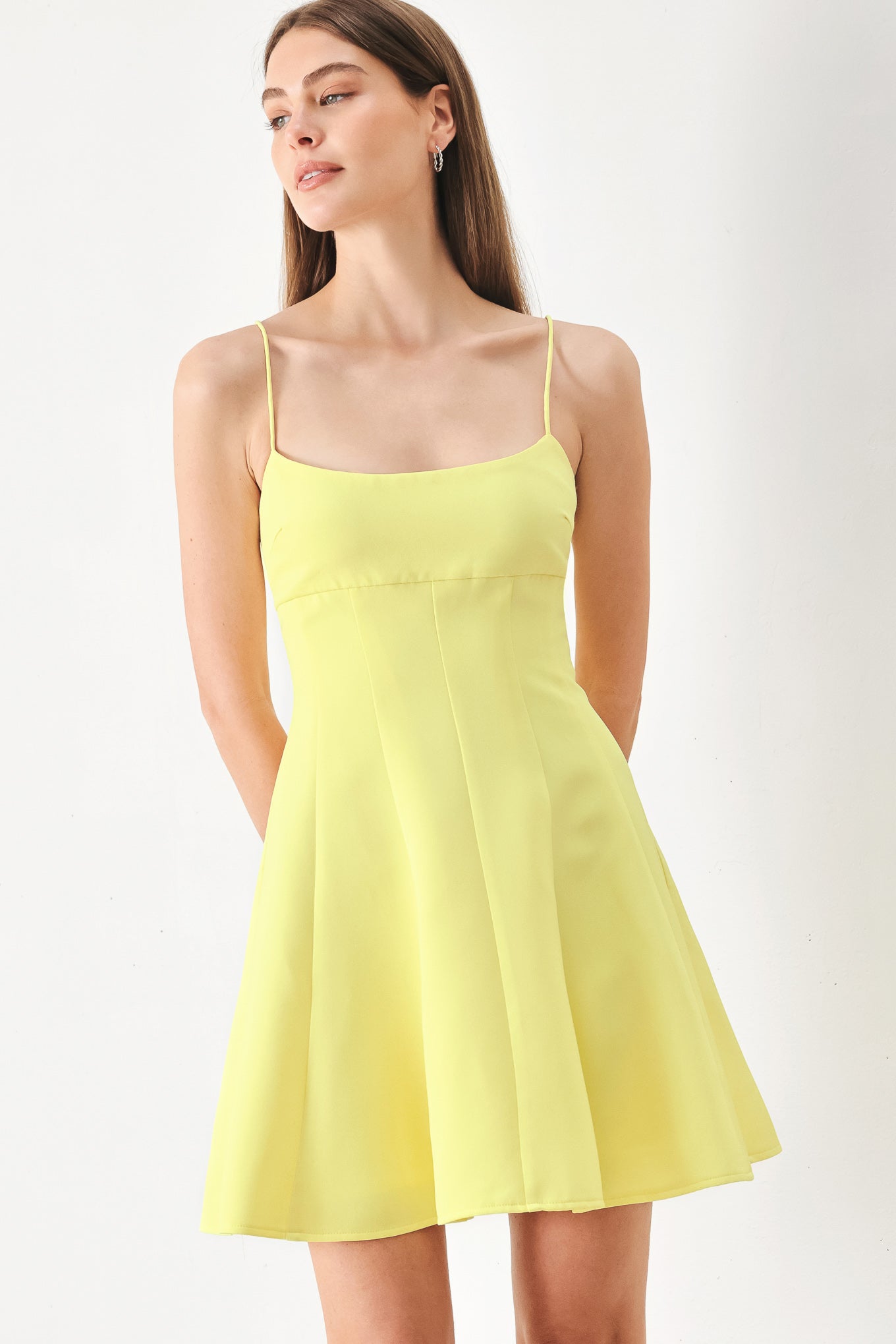 Woman wearing a yellow cami dress with strap, circle skirt and back zipper | FREEMARKET | Flying Tomato