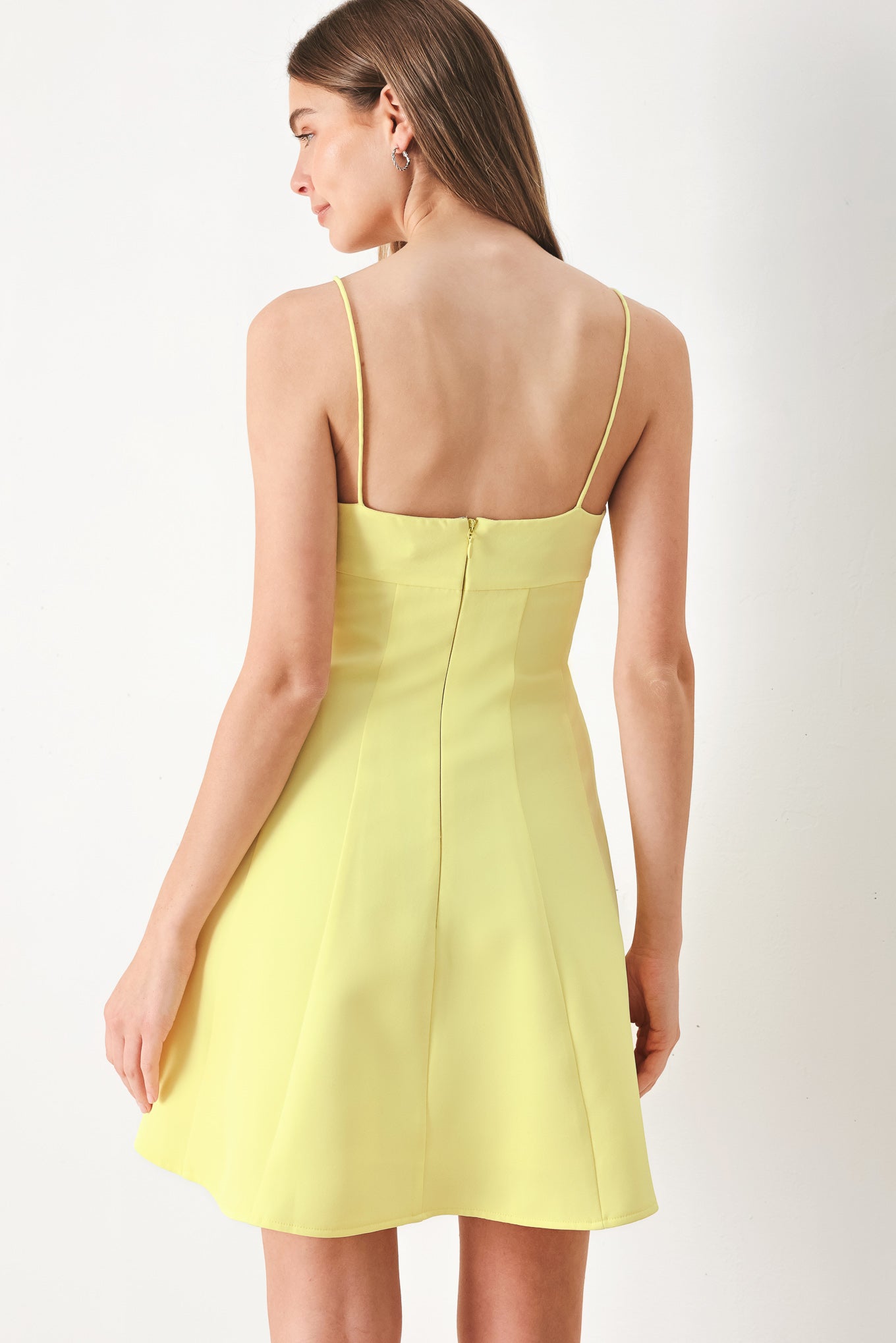 Woman wearing a yellow cami dress with strap, circle skirt and back zipper | FREEMARKET | Flying Tomato