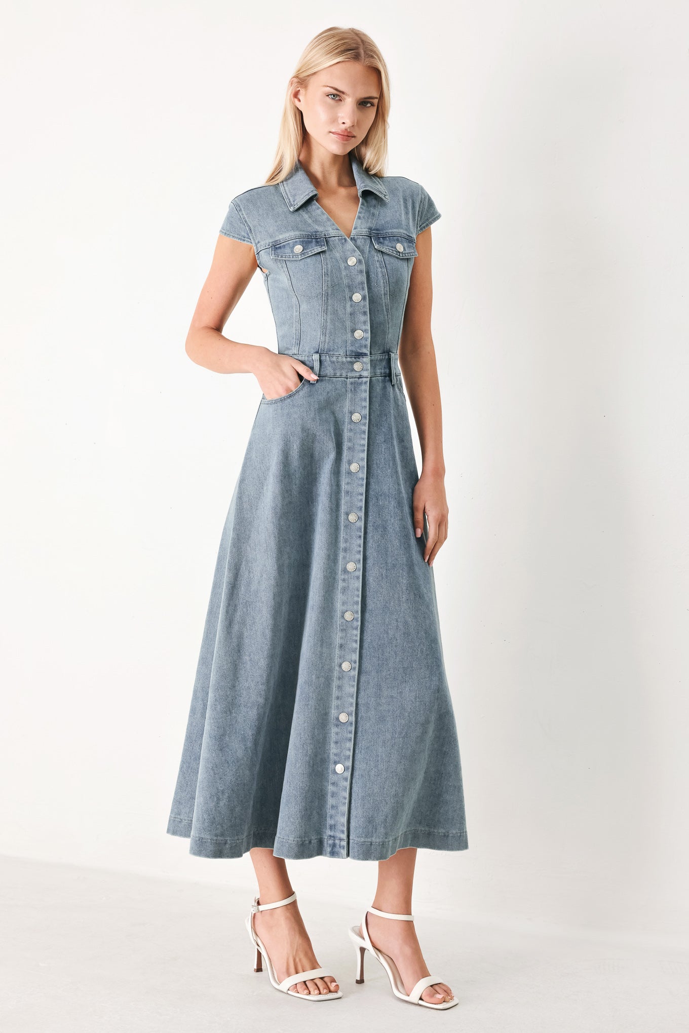 Woman wearing acid washed denim midi dress featuring collar with V neck, cap sleeve, front button down, pockets and circle skirt | FREEMARKET