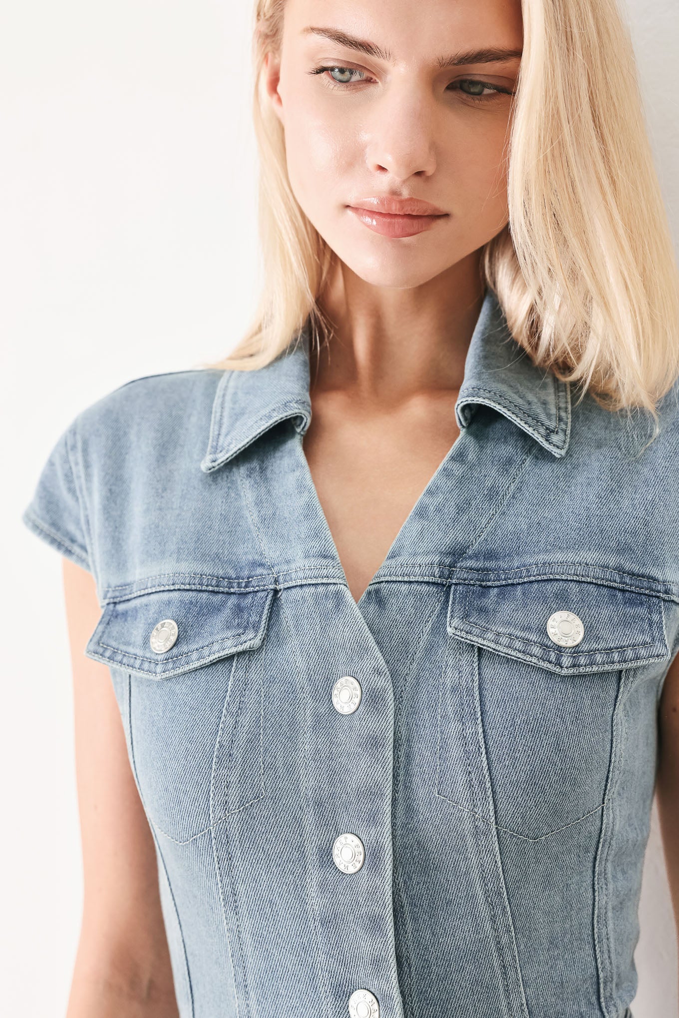 Woman wearing acid washed denim midi dress featuring collar with V neck, cap sleeve, front button down, pockets and circle skirt | FREEMARKET