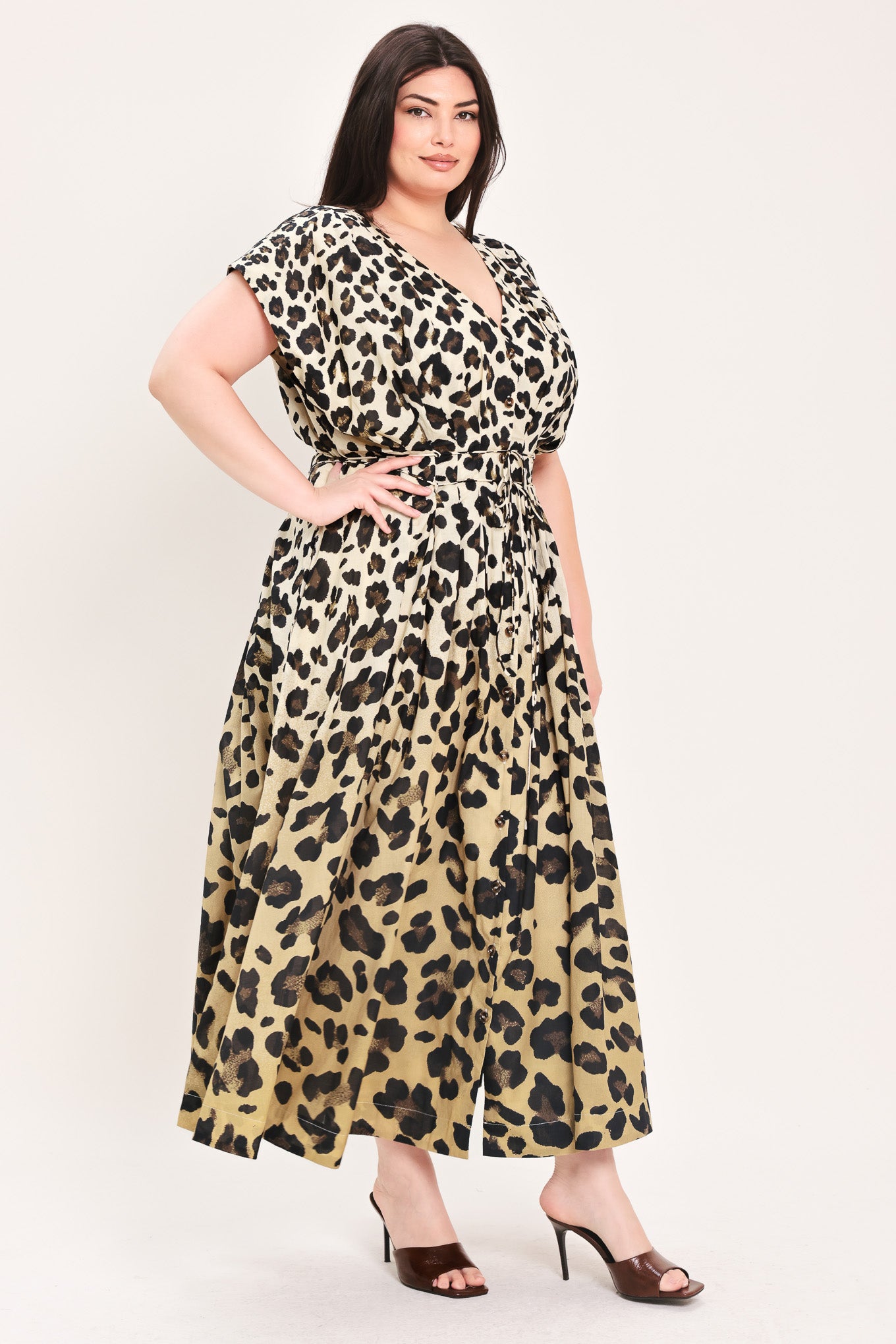 Woman wearing a leopard print woven midi dress featuring V neckline, drop shoulder, front button down, corset waist with pleats, double tie, side pockets and full skirt | FREEMARKET