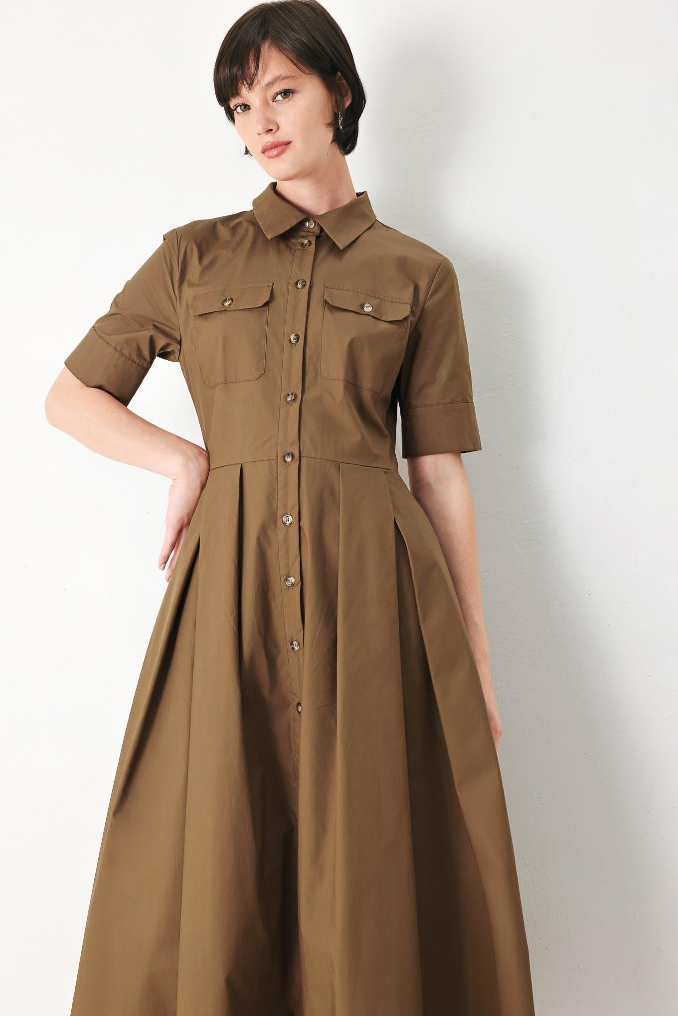 A solid brown woven midi shirt dress with short sleeve, pockets, self tie and front closure