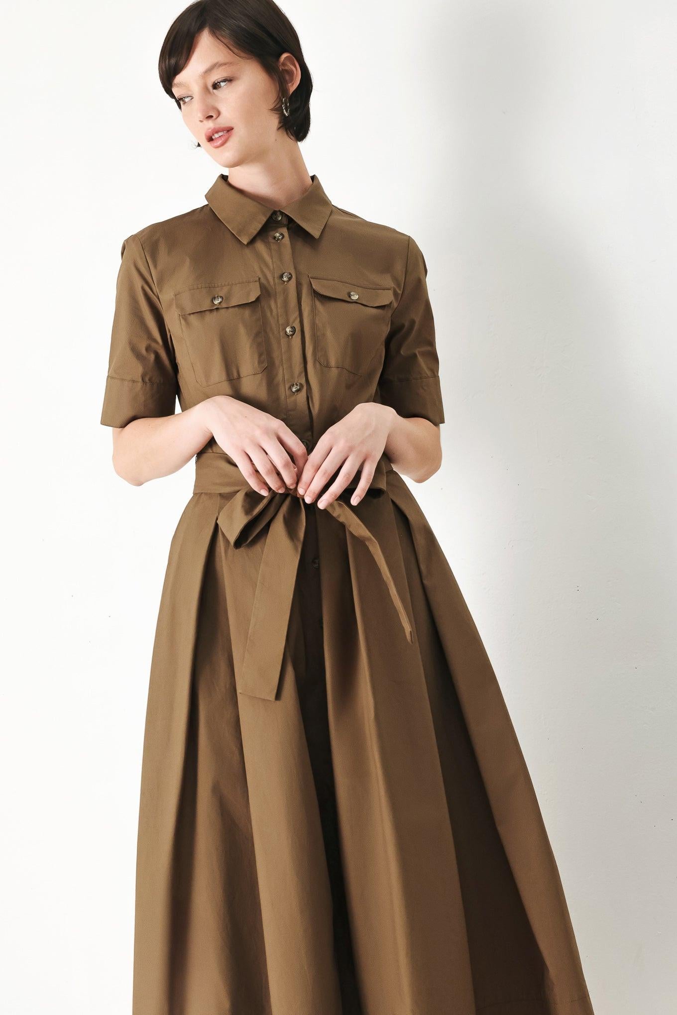 A solid brown woven midi shirt dress with short sleeve, pockets, self tie and front closure