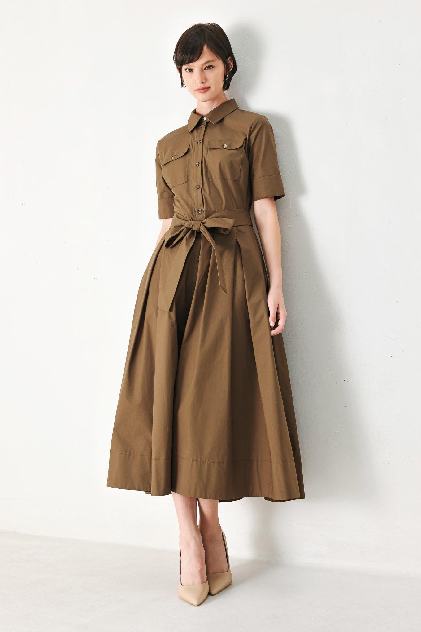 A solid brown woven midi shirt dress with short sleeve, pockets, self tie and front closure