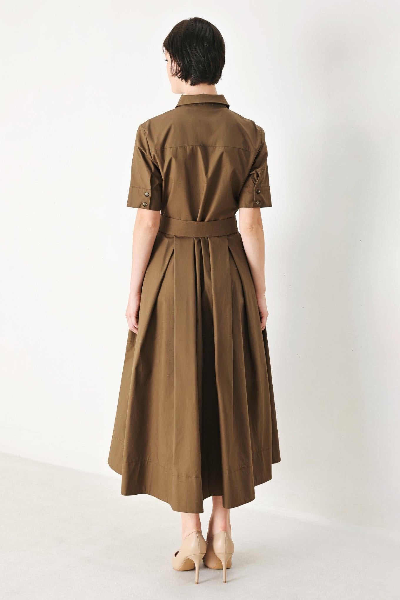 A solid brown woven midi shirt dress with short sleeve, pockets, self tie and front closure
