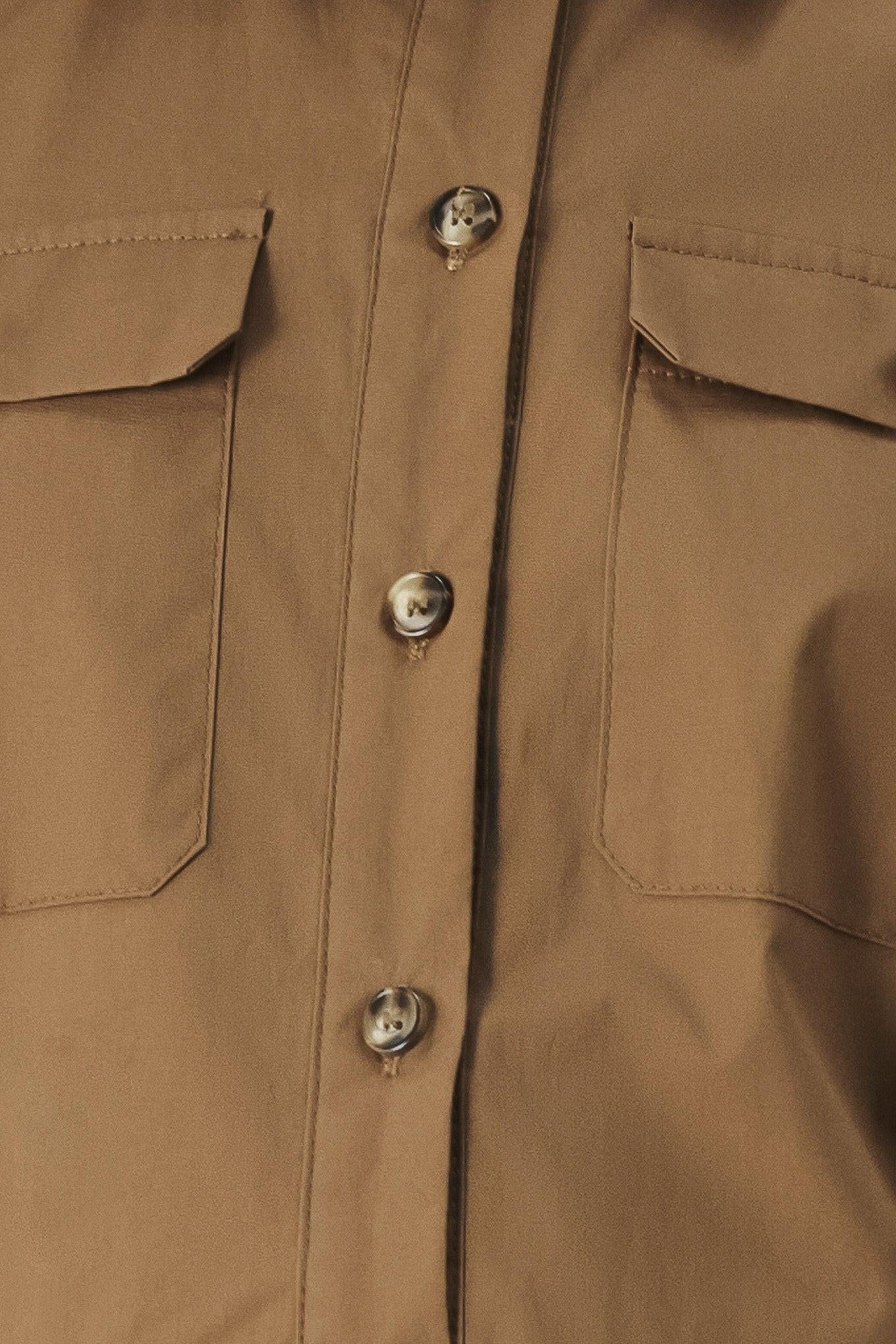 A solid brown woven midi shirt dress with short sleeve, pockets, self tie and front closure