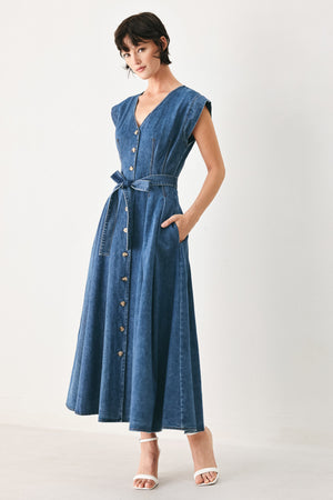 Woman wearing a short sleeve blue denim midi dress with V neckline, front button down, corset waist, self sash tie and full skirt | FREEMARKET