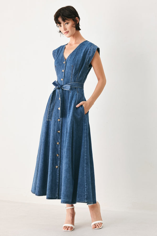 Woman wearing a short sleeve blue denim midi dress with V neckline, front button down, corset waist, self sash tie and full skirt | FREEMARKET