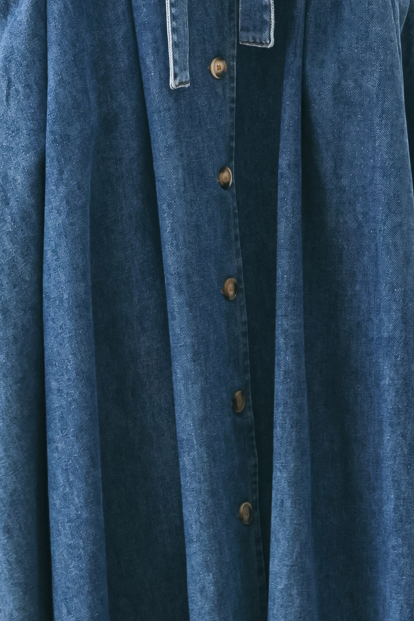 Woman wearing a short sleeve blue denim midi dress with V neckline, front button down, corset waist, self sash tie and full skirt | FREEMARKET