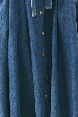 Woman wearing a short sleeve blue denim midi dress with V neckline, front button down, corset waist, self sash tie and full skirt | FREEMARKET