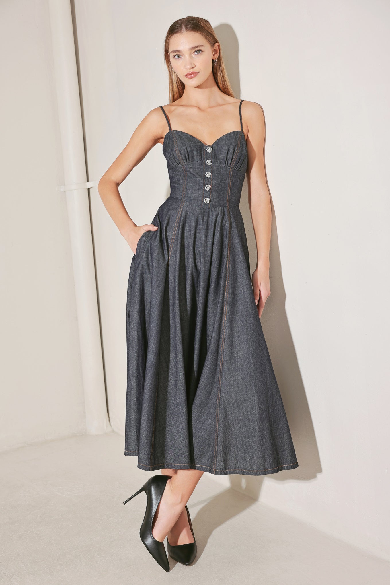 
A denim midi dress featuring sweetheart neckline, straps, bra cup, corset waist, jewel button, circle skirt and back zipper closure

Details:

Self : 95% Cotton 5% Polyester

Size &amp; Fit

- Model is 5`8" And Wearing Size Small
- Measurements Taken From Size Small
- Approx. Length: 49"