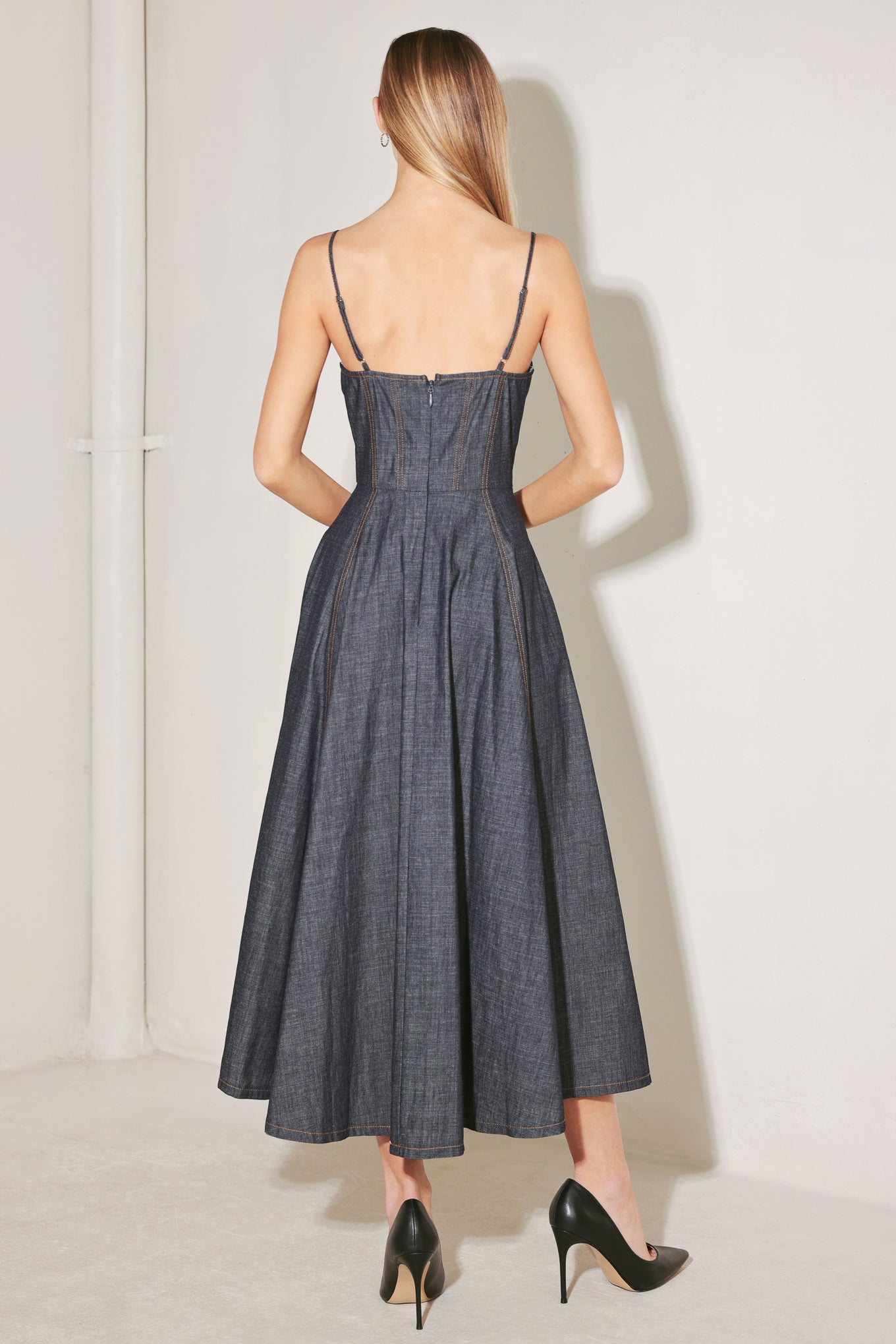 
A denim midi dress featuring sweetheart neckline, straps, bra cup, corset waist, jewel button, circle skirt and back zipper closure

Details:

Self : 95% Cotton 5% Polyester

Size &amp; Fit

- Model is 5`8" And Wearing Size Small
- Measurements Taken From Size Small
- Approx. Length: 49"