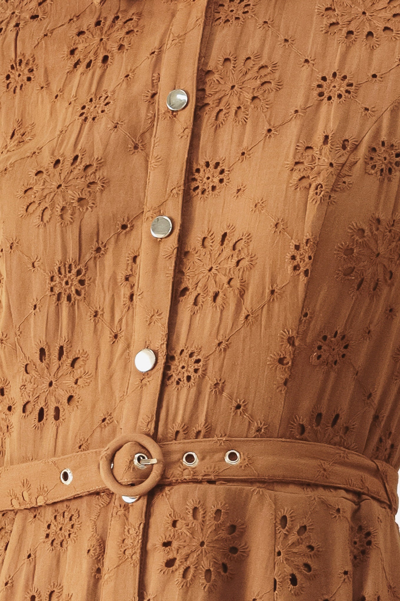 Close up of a camel colored eyelet midi dress featuring collar, short sleeve, front button closure, self belt, side pockets and full skirt | FREEMARKET