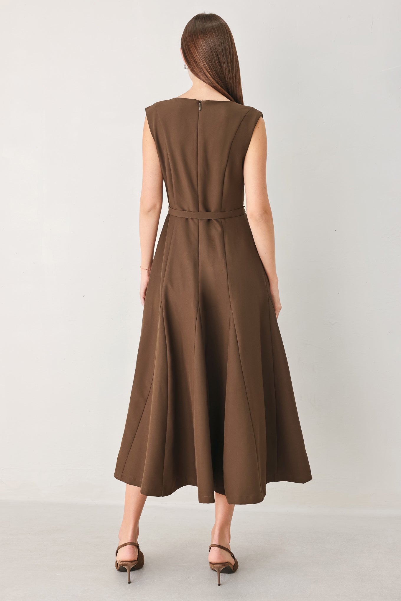 Woman wearing a brown woven midi dress featuring round neckline, sleeveless, self belt, full circle skirt and back zipper closure | FREEMARKET