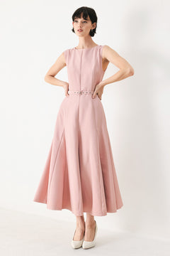 Woman wearing a pink midi dress featuring round neckline, sleeveless, self belt, full circle skirt and back zipper closure | FREEMARKET