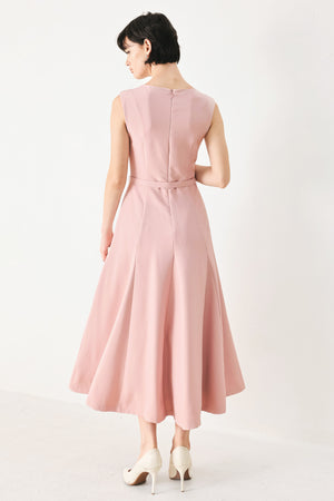 Woman wearing a pink midi dress featuring round neckline, sleeveless, self belt, full circle skirt and back zipper closure | FREEMARKET