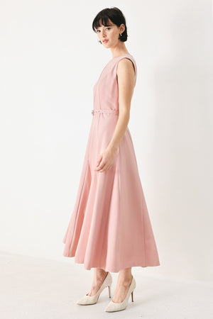 Woman wearing a pink midi dress featuring round neckline, sleeveless, self belt, full circle skirt and back zipper closure | FREEMARKET