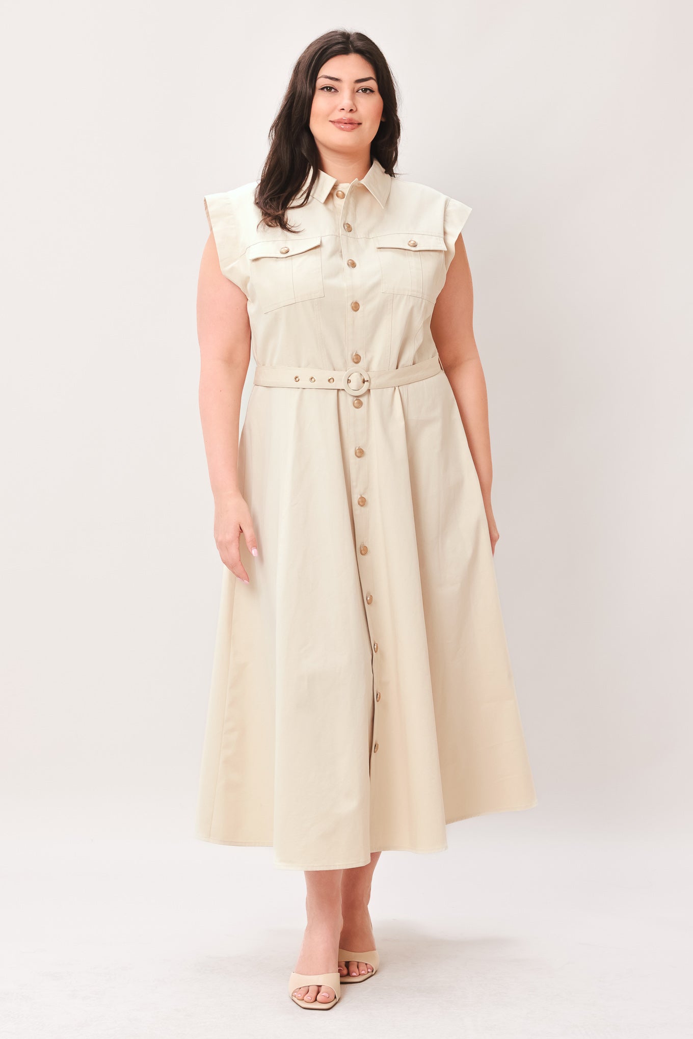 Woman wearing a beige dress with buttons on a white background | FREEMARKET | Flying Tomato
