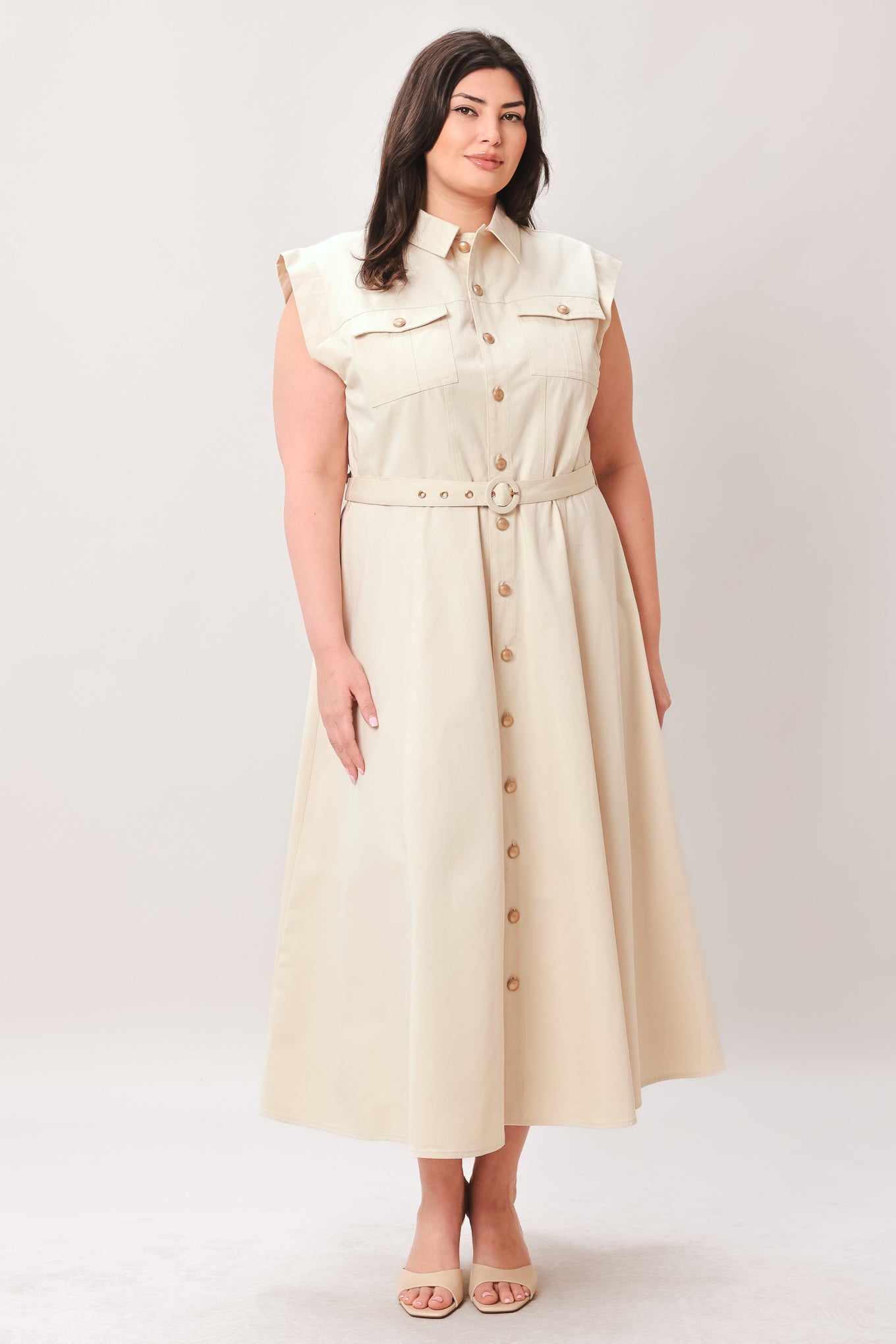 Woman wearing a beige dress with buttons on a white background | FREEMARKET | Flying Tomato