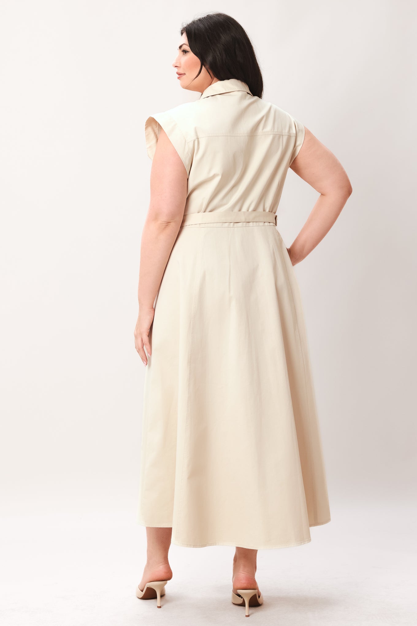 Woman wearing a beige dress with buttons on a white background | FREEMARKET | Flying Tomato