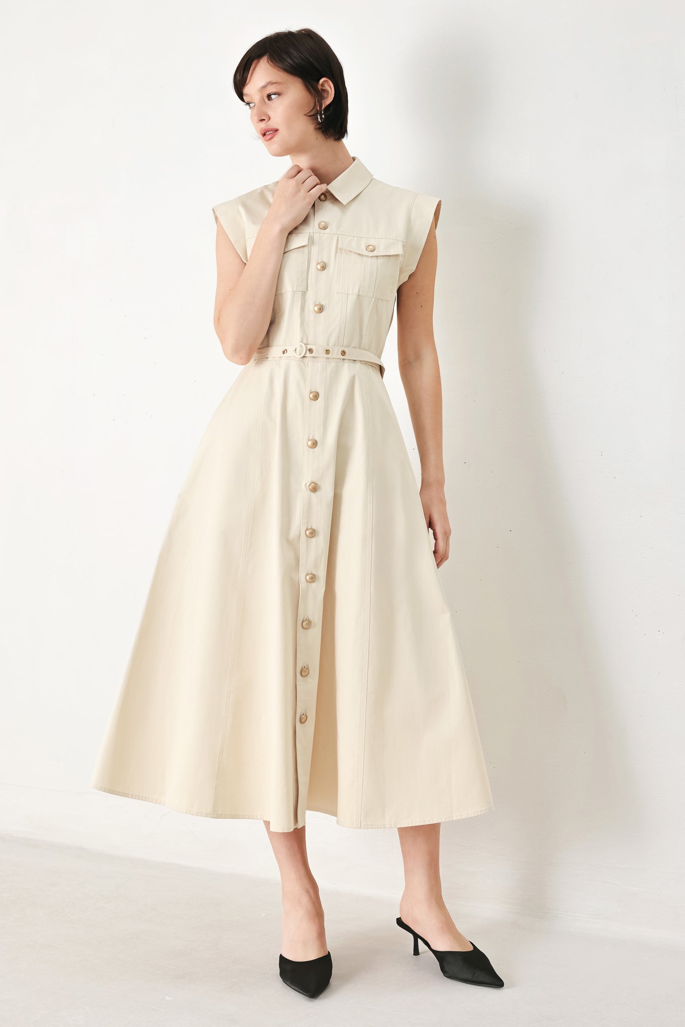 A solid woven shirt dress with front pocket, self belt and closure