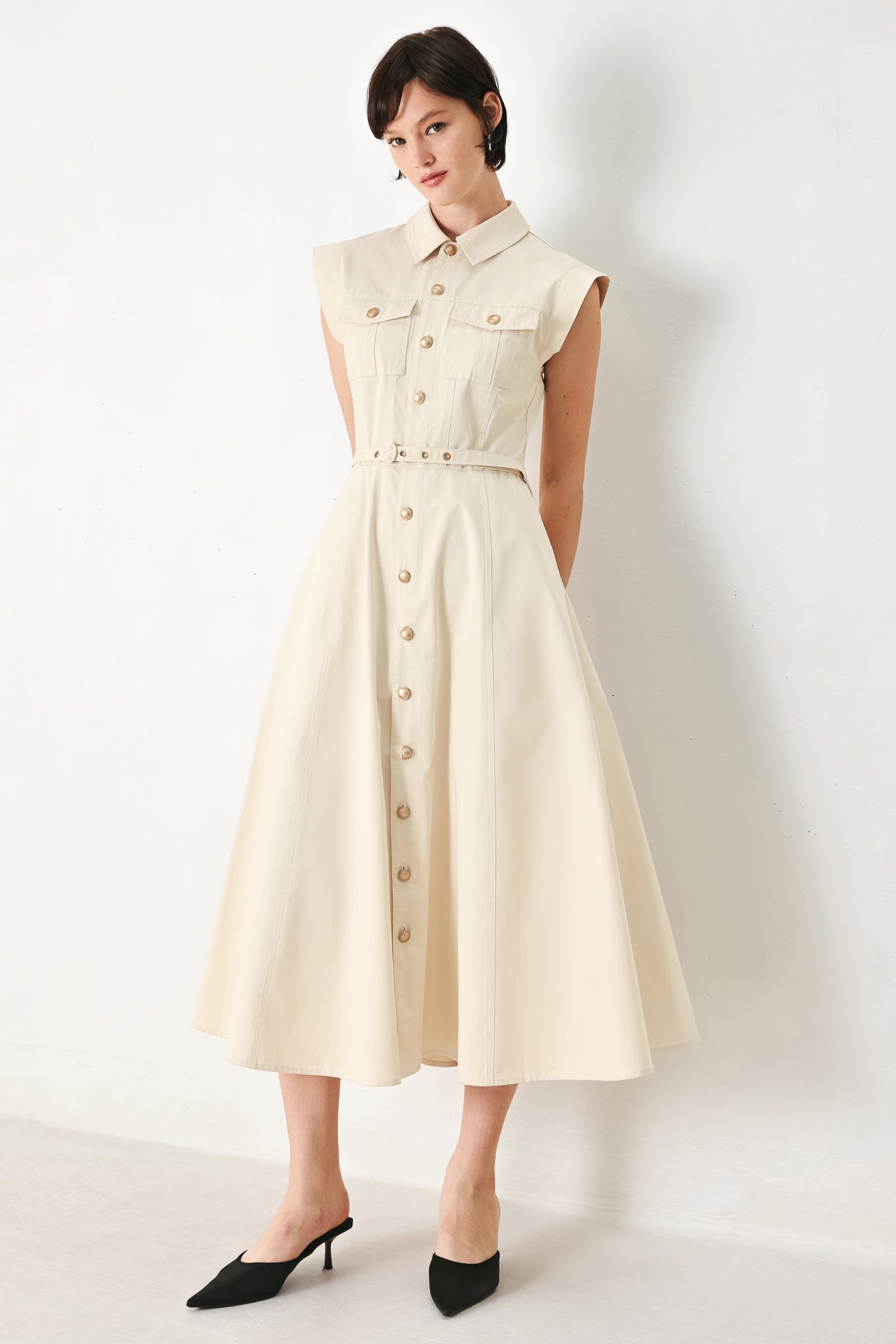 A solid woven shirt dress with front pocket, self belt and closure