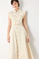 A solid woven shirt dress with front pocket, self belt and closure