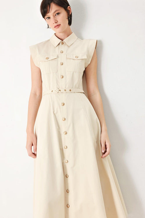 A solid woven shirt dress with front pocket, self belt and closure