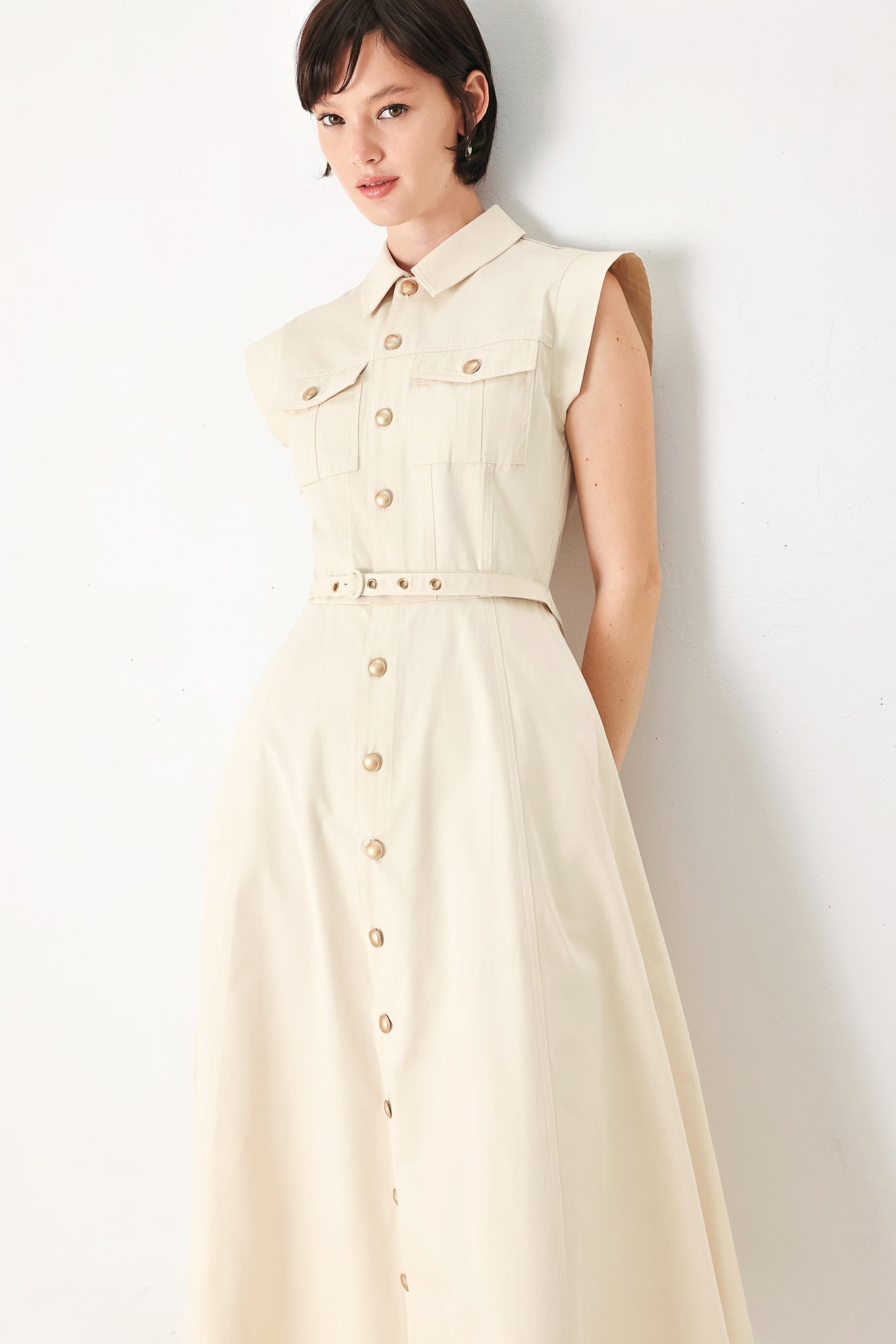 A solid woven shirt dress with front pocket, self belt and closure