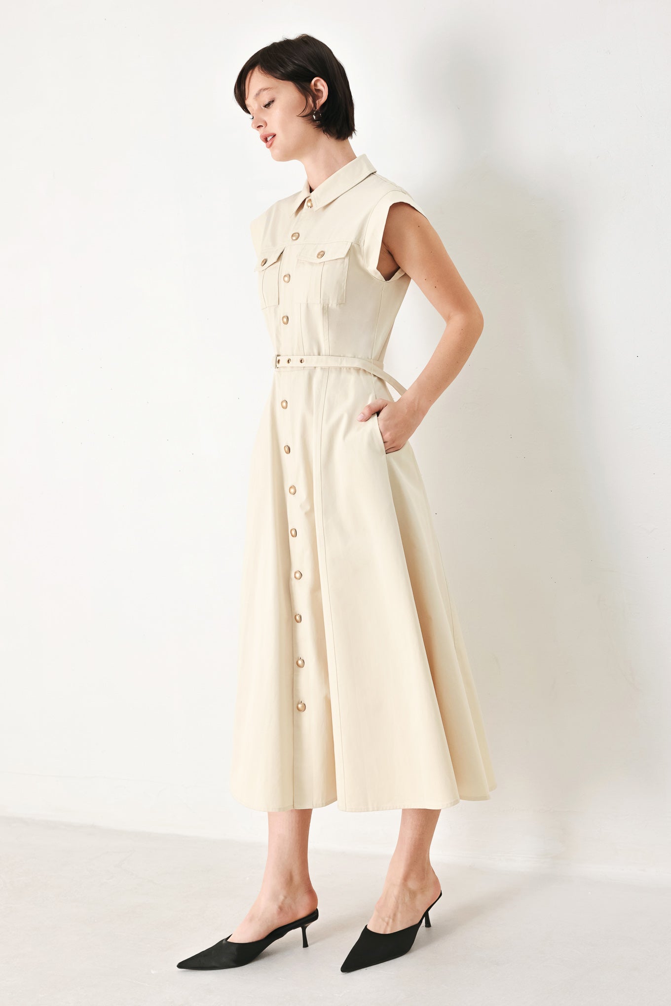 A solid woven shirt dress with front pocket, self belt and closure