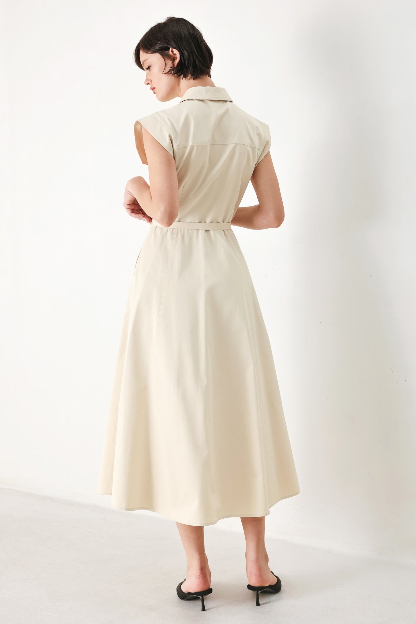 A solid woven shirt dress with front pocket, self belt and closure