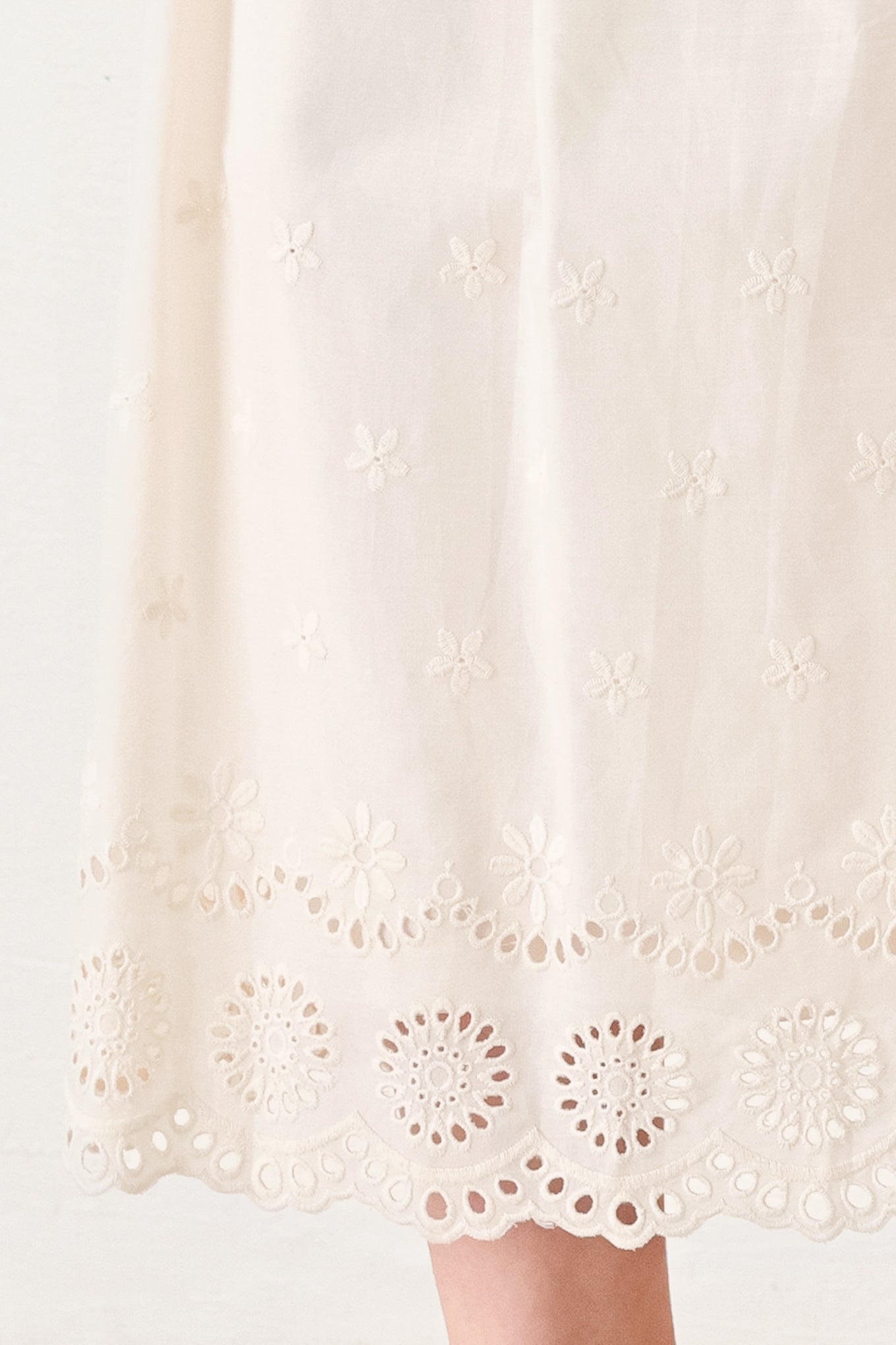 Close up of ivory midi dress featuring woven eyelet skirt | FREEMARKET
