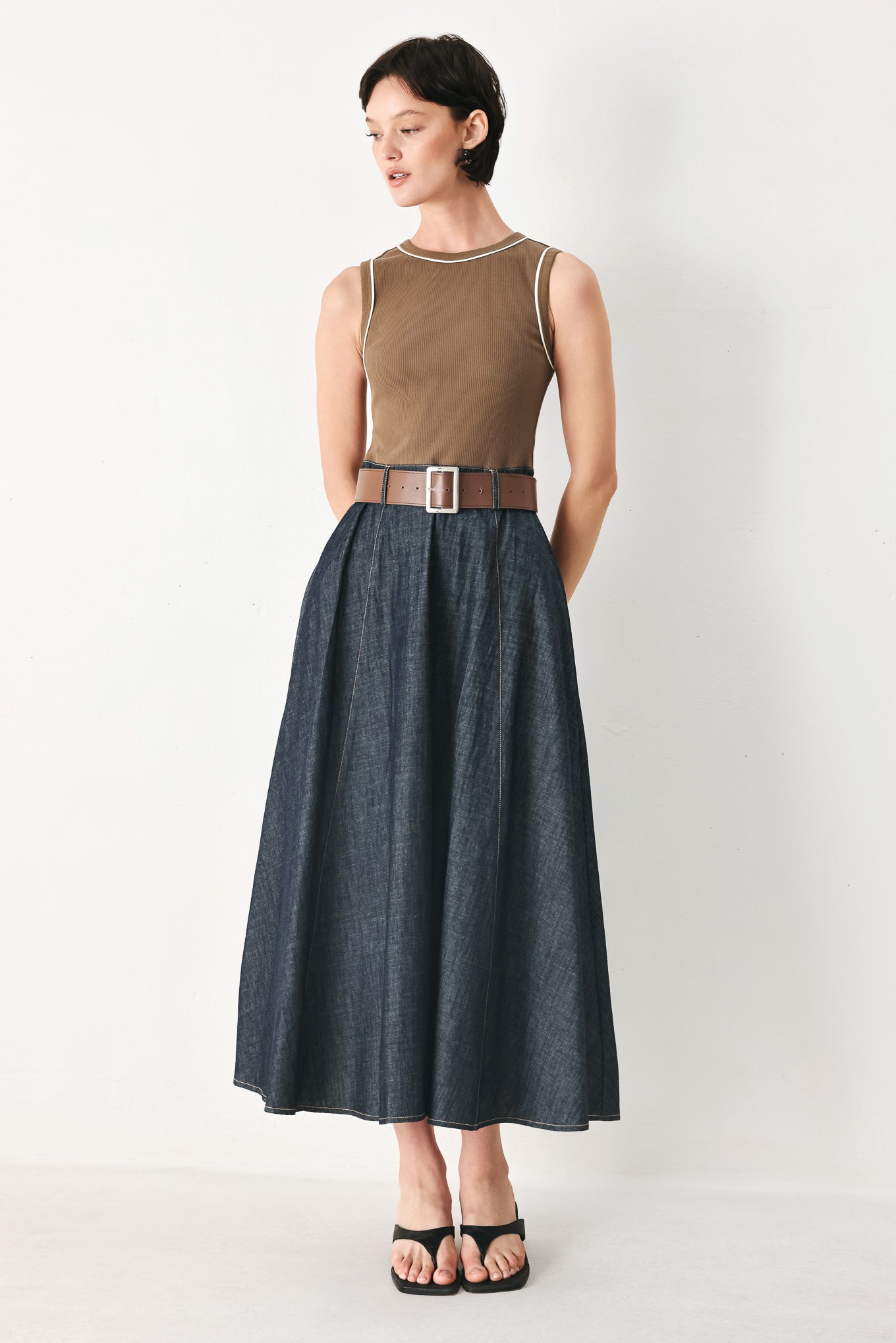 Woman wearing a sleeveless midi dress with a brown knit top and dark denim combination with a contrasting belt and back zipper closure | FREEMARKET