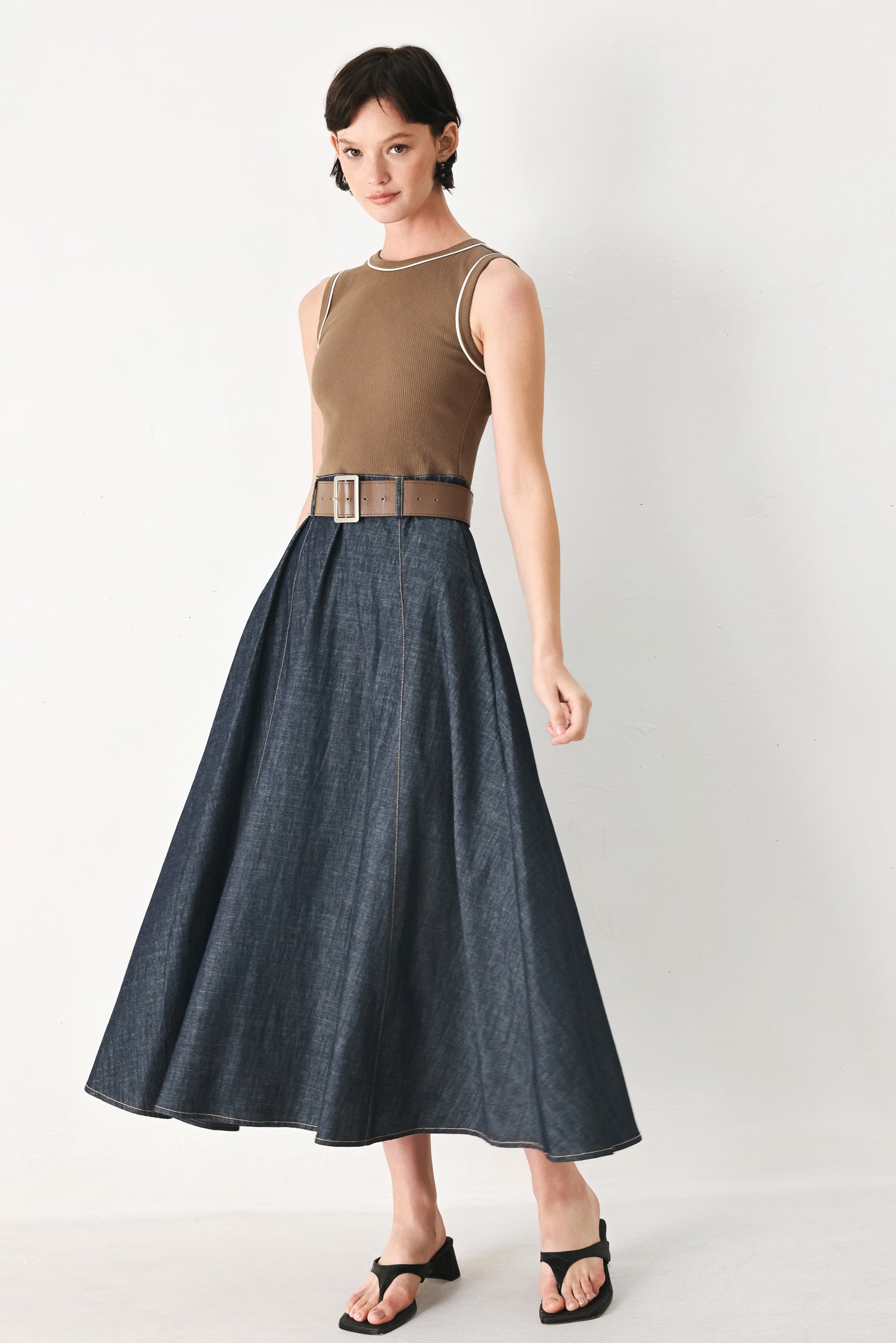 Woman wearing a sleeveless midi dress with a brown knit top and dark denim combination with a contrasting belt and back zipper closure | FREEMARKET