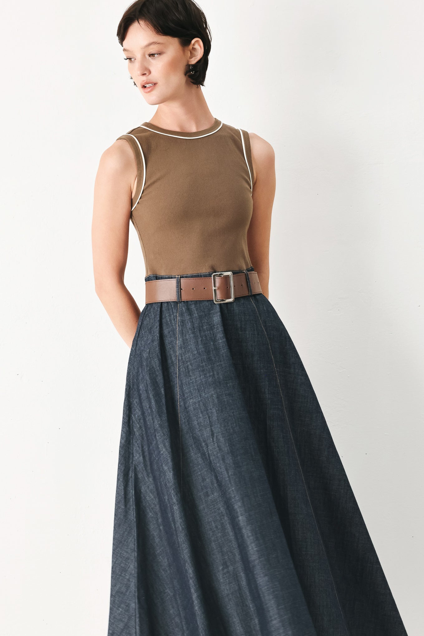 Woman wearing a sleeveless midi dress with a brown knit top and dark denim combination with a contrasting belt and back zipper closure | FREEMARKET