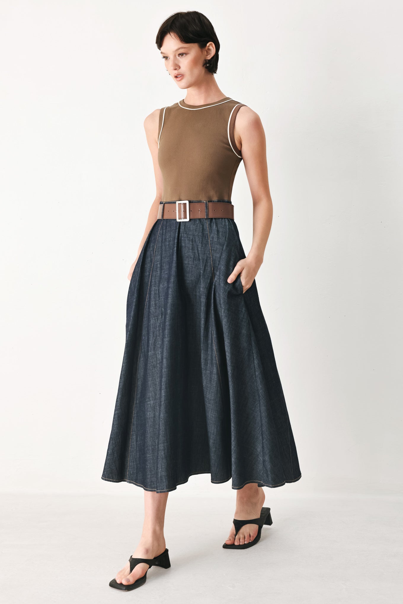 Woman wearing a sleeveless midi dress with a brown knit top and dark denim combination with a contrasting belt and back zipper closure | FREEMARKET