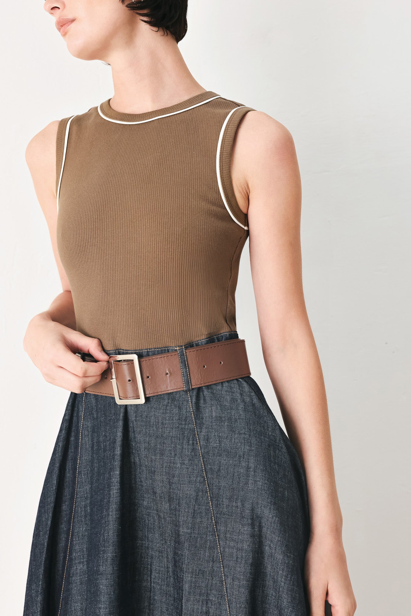 Woman wearing a sleeveless midi dress with a brown knit top and dark denim combination with a contrasting belt and back zipper closure | FREEMARKET