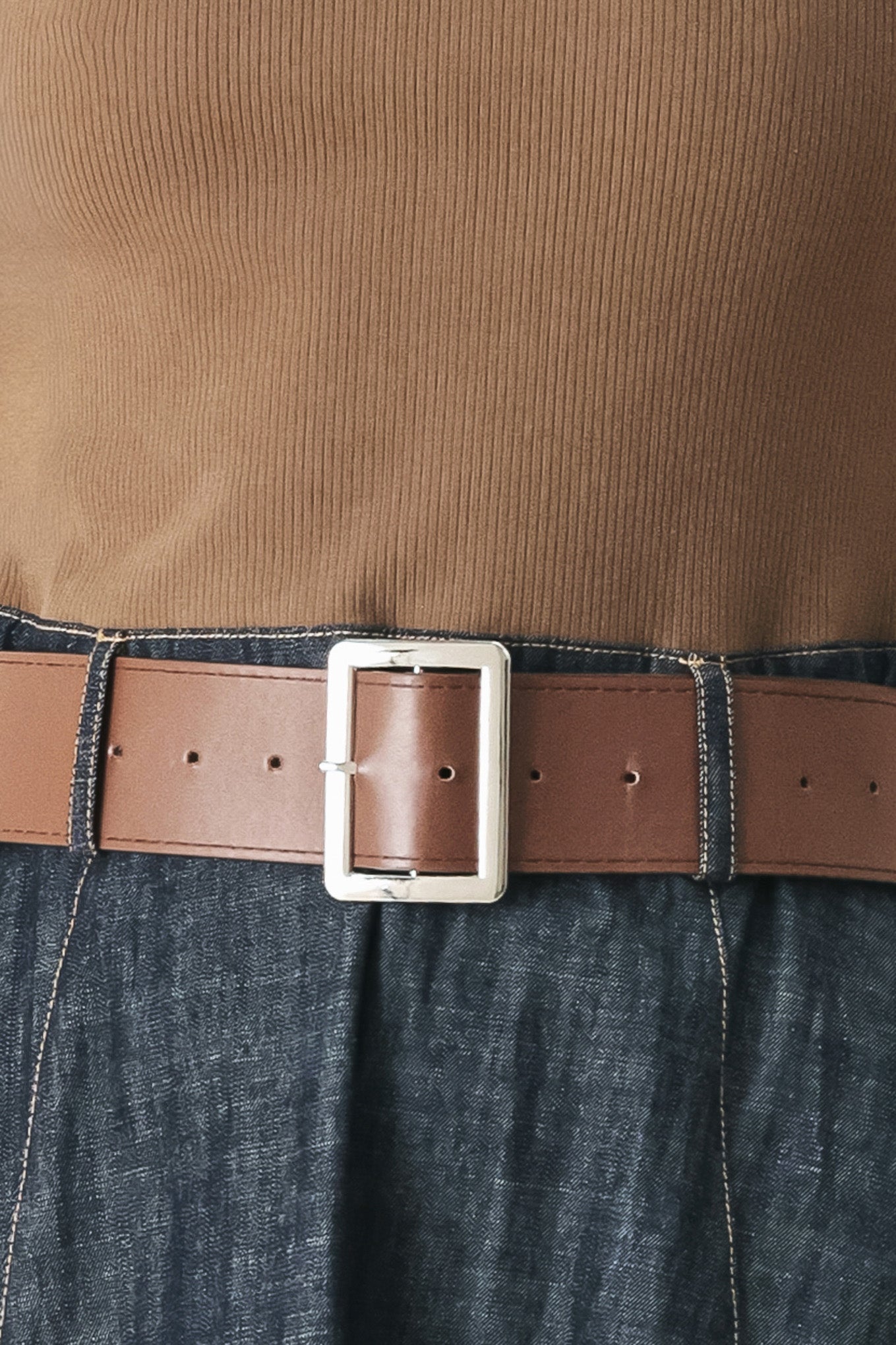 Woman wearing a sleeveless midi dress with a brown knit top and dark denim combination with a contrasting belt and back zipper closure | FREEMARKET
