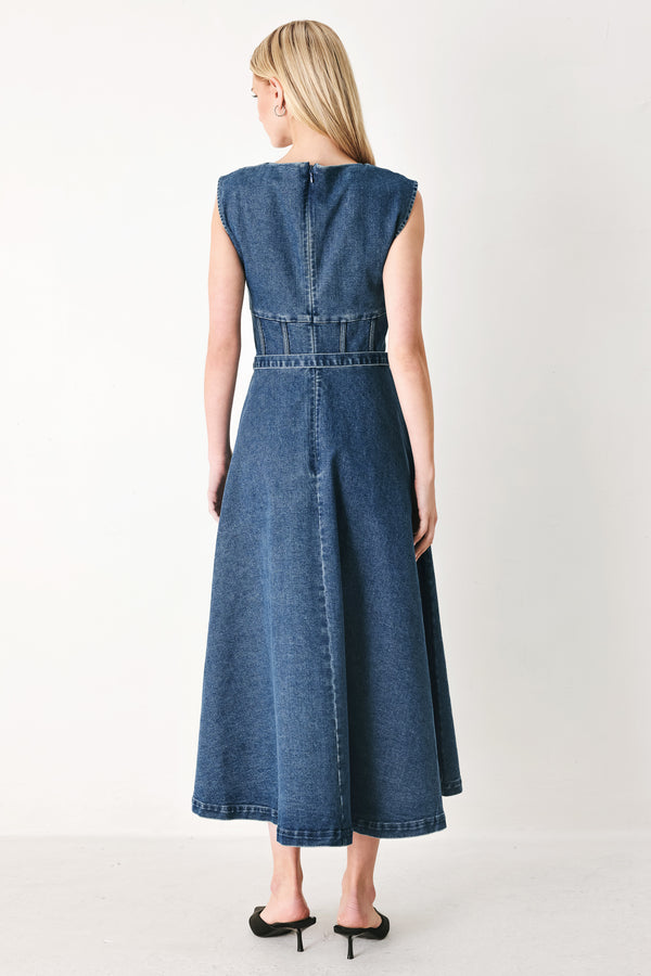 Woman wearing a blue denim midi dress featuring square neckline, corset waist, self belt, side pockets and back zipper closure | FREEMARKET