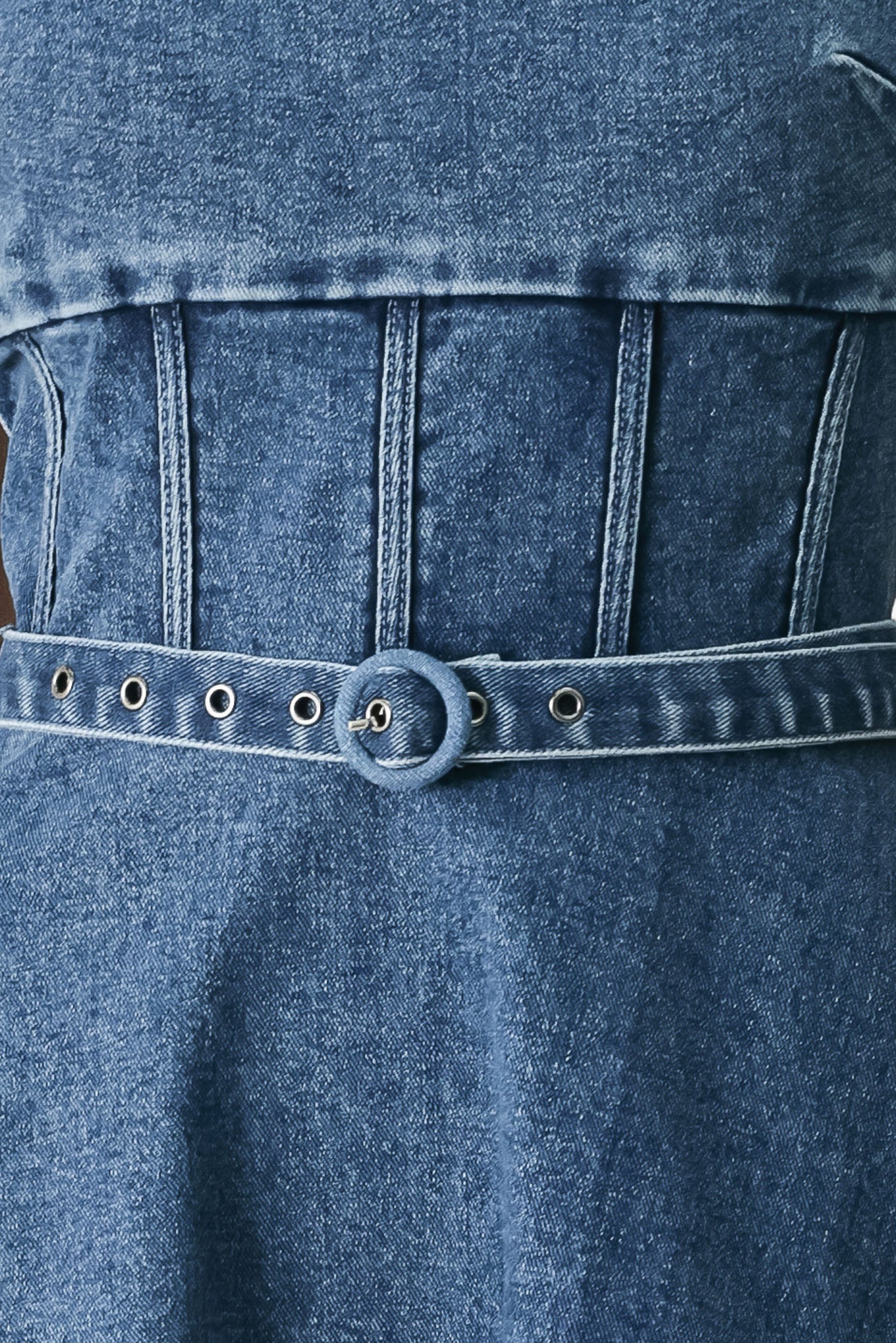 Close up of a blue denim midi dress featuring square neckline, corset waist, self belt, side pockets and back zipper closure | FREEMARKET