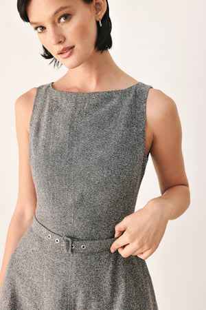 A woman modeling a sleeveless gray midi dress with a structured bodice, defined waist, and flared skirt | FREEMARKET