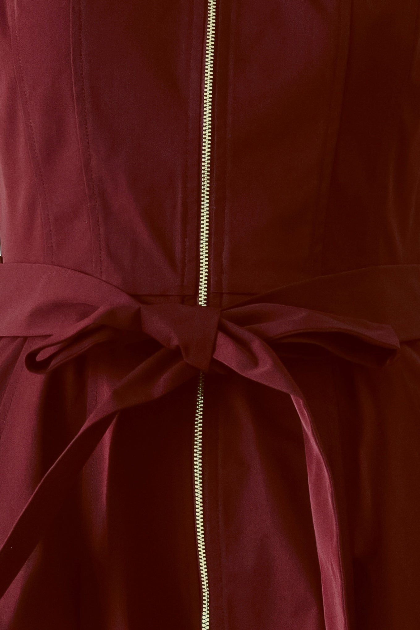 Close up of a burgundy red woven midi dress featuring collar, sleeveless, front zipper closure, self sash tie, pockets and full skirt | FREEMARKET