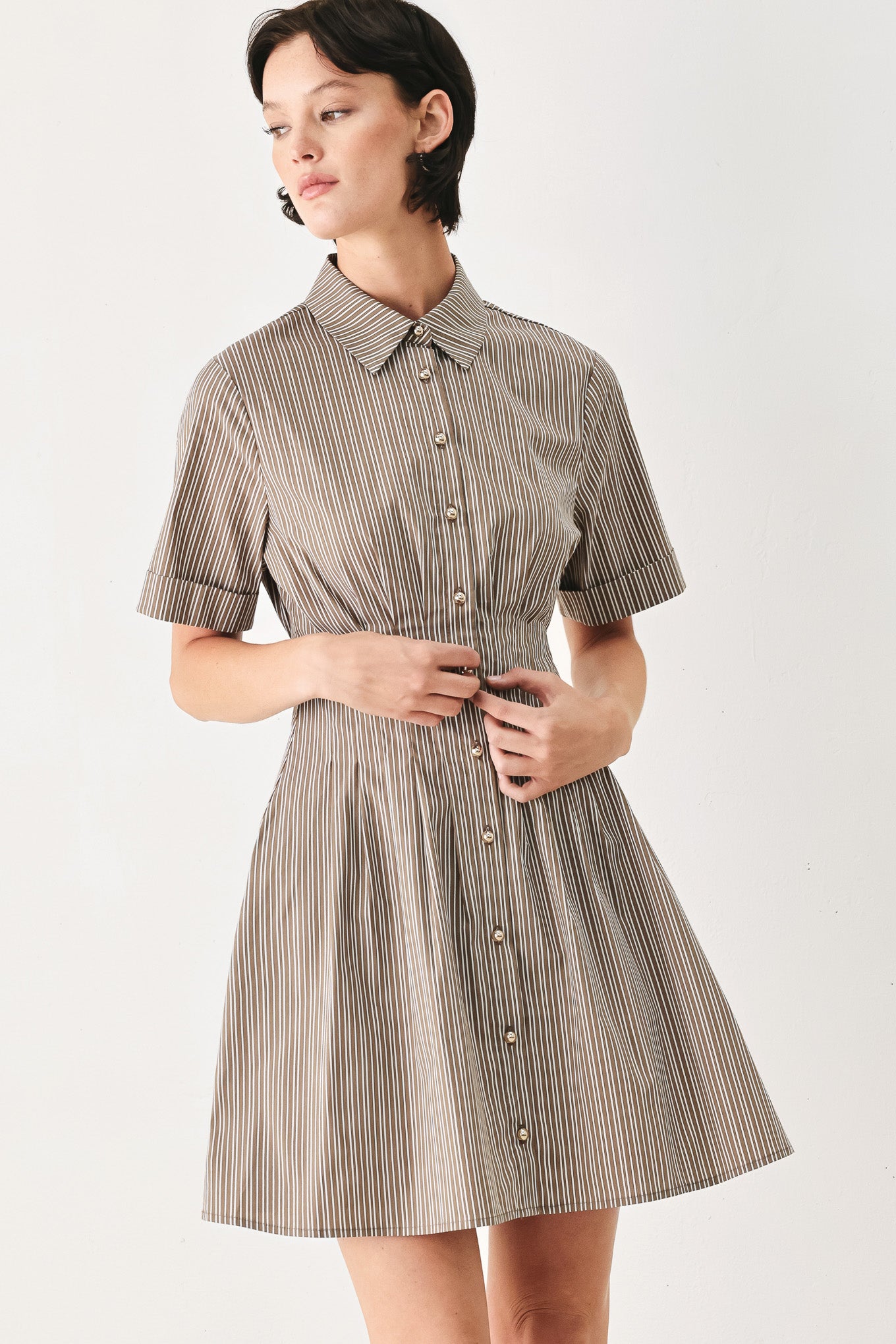 Woman wearing a multi colored taupe short sleeve striped woven mini dress with front button closure, corset waist and circle skirt | FREEMARKET