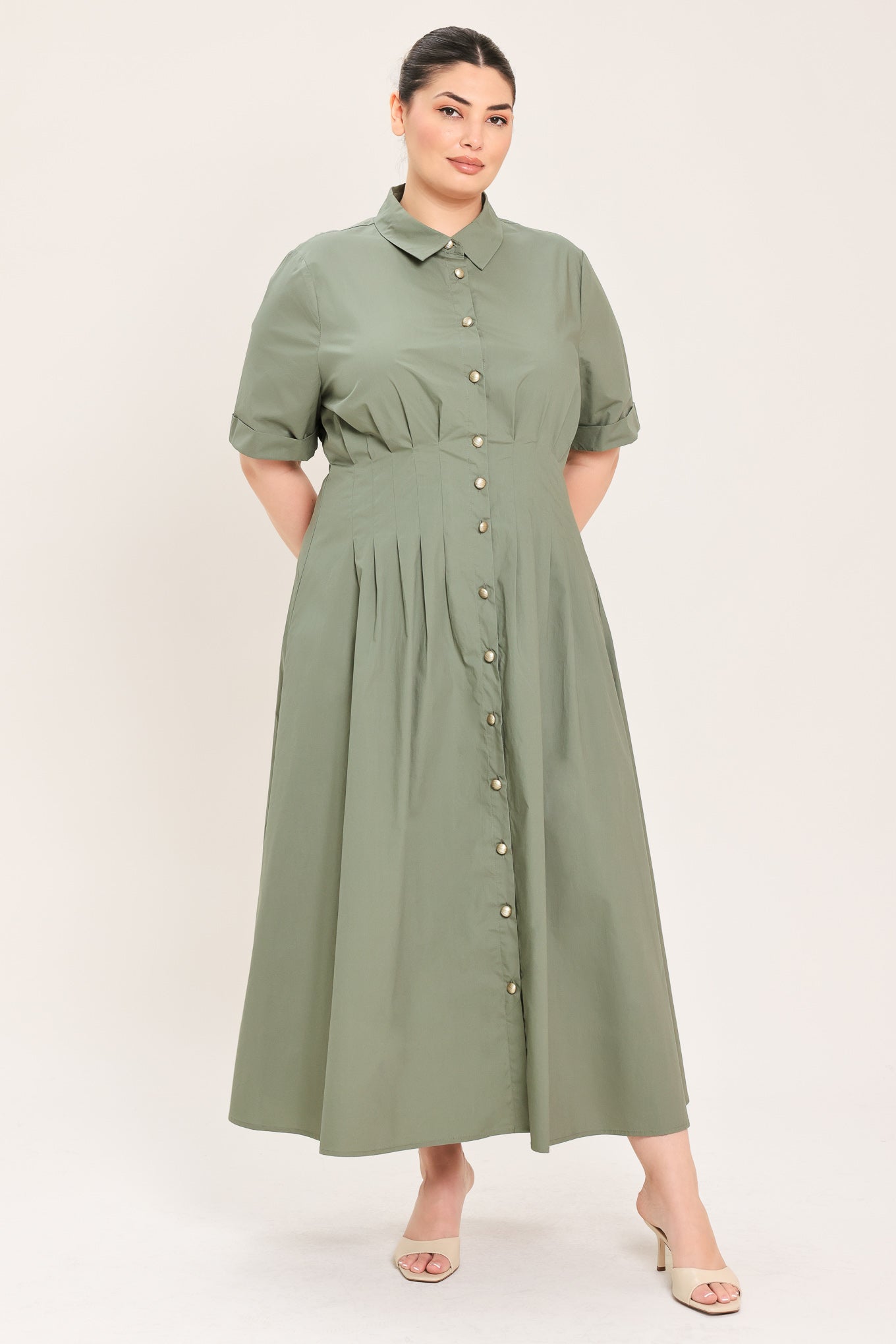 A woman modeling a olive green midi shirt dress with short sleeves, a button-down front, and a gathered waist | Plus Curve Flying Tomato