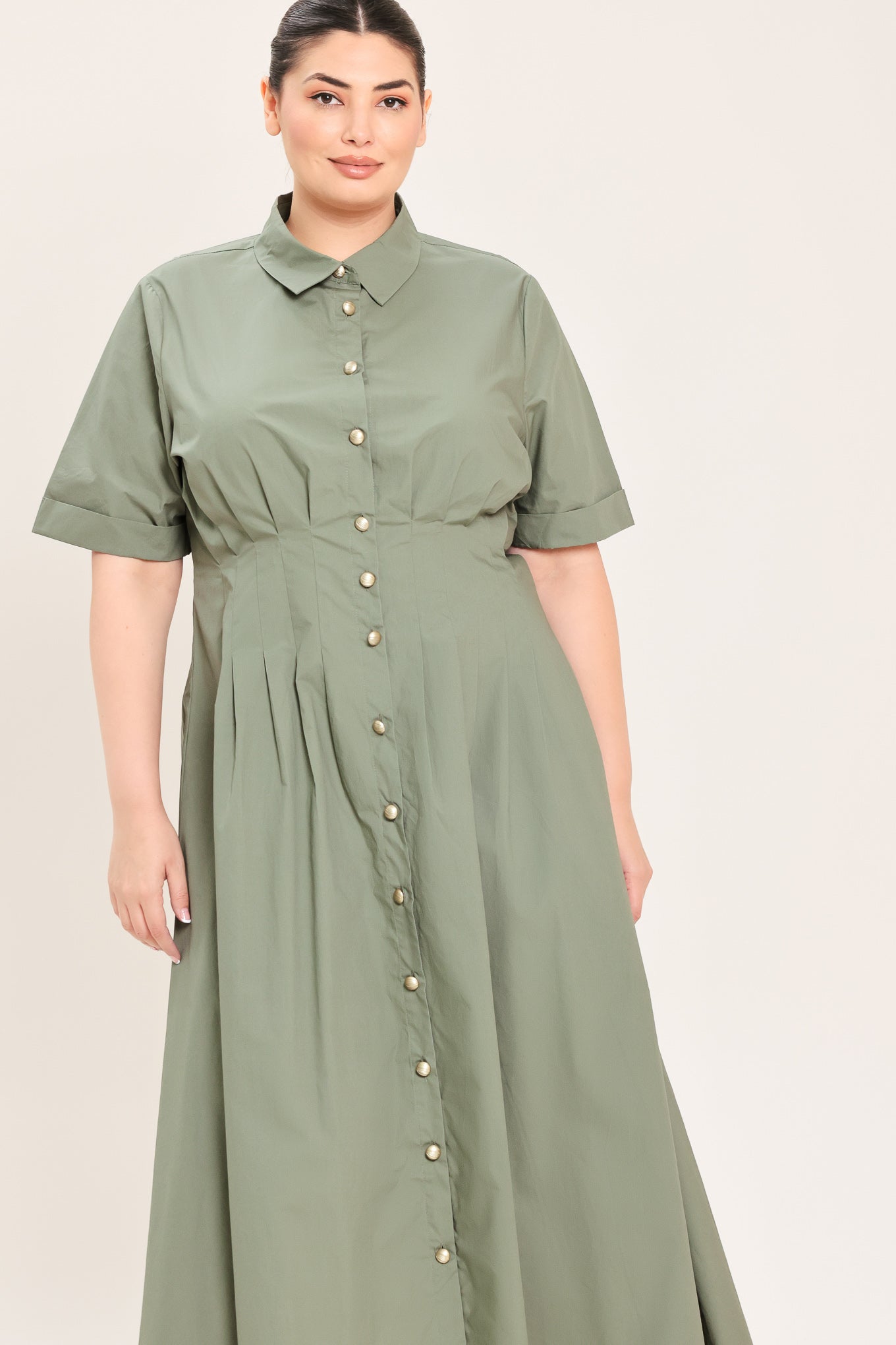 A woman modeling a olive green midi shirt dress with short sleeves, a button-down front, and a gathered waist | Plus Curve Flying Tomato