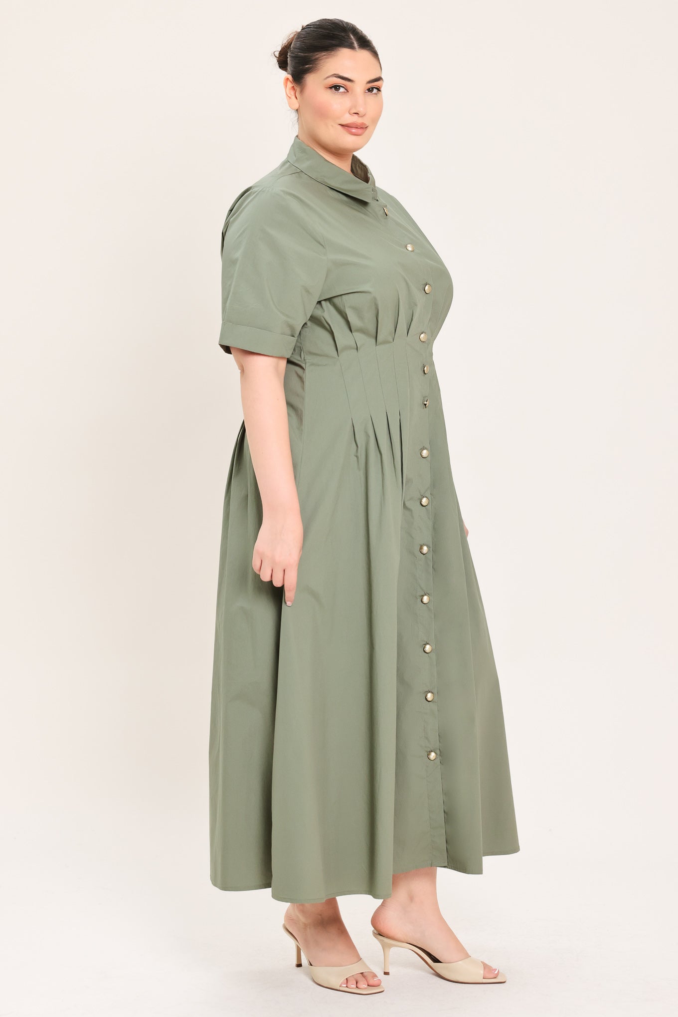 A woman modeling a olive green midi shirt dress with short sleeves, a button-down front, and a gathered waist | Plus Curve Flying Tomato