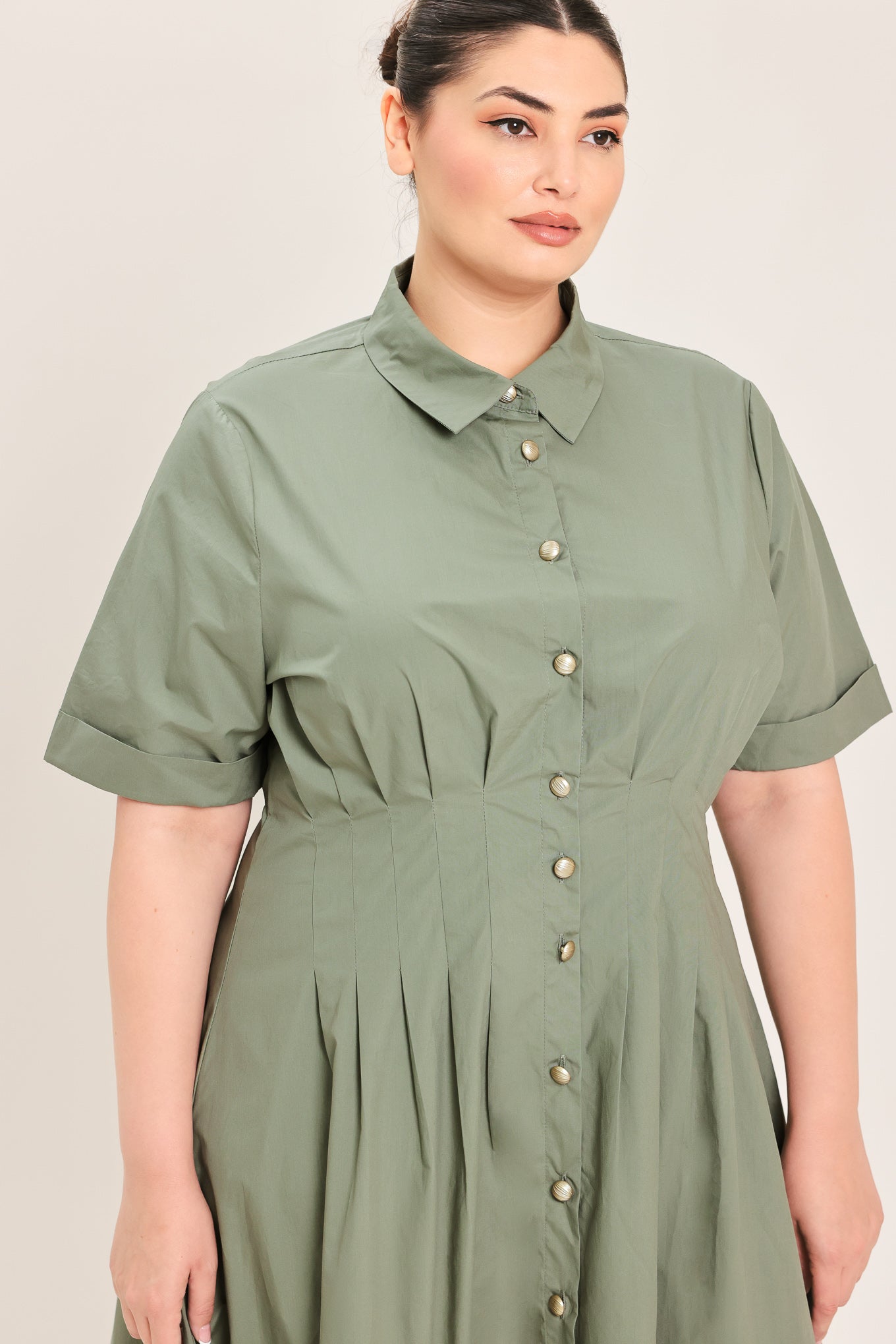 A woman modeling a olive green midi shirt dress with short sleeves, a button-down front, and a gathered waist | Plus Curve Flying Tomato